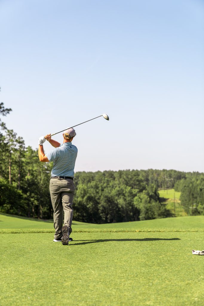 Man golfing Hollow Creek